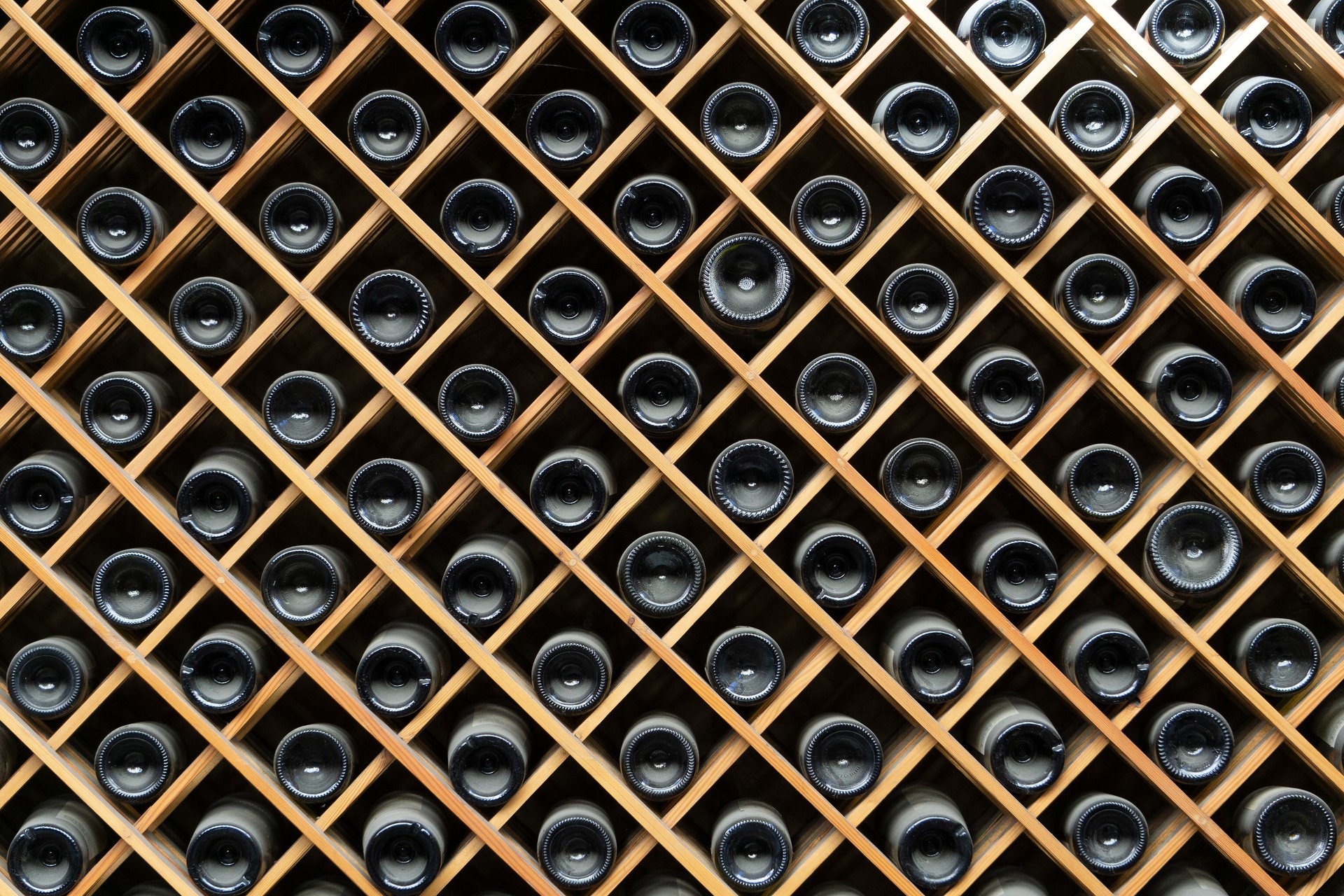 Wine bottles background. Bottles of red and white wine in a wine cabinet of a liquor store